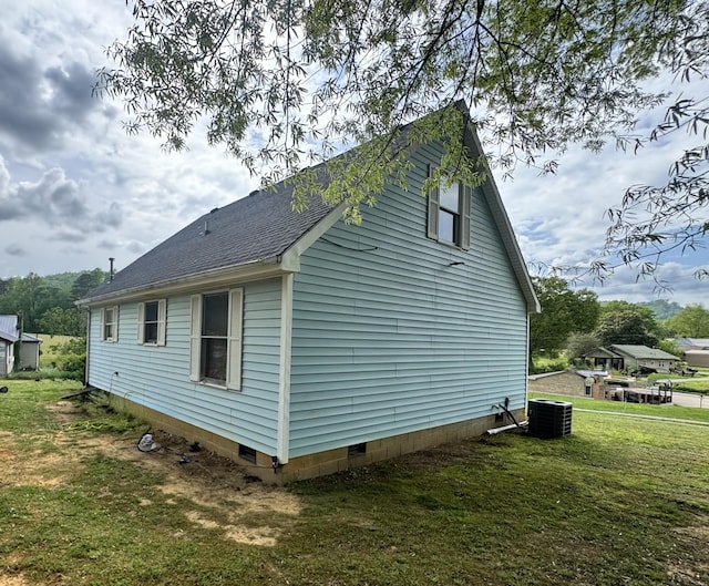 68 Red Witt Rd, Williamsburg, KY 40769 - view of side of property featuring a lawn, a shingled roof, and central air condition unit