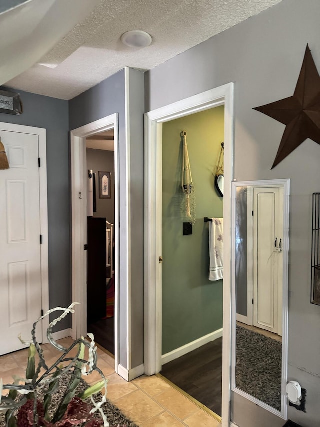 68 Red Witt Rd, Williamsburg, KY 40769 - bathroom featuring tile patterned floors, a textured ceiling, and baseboards