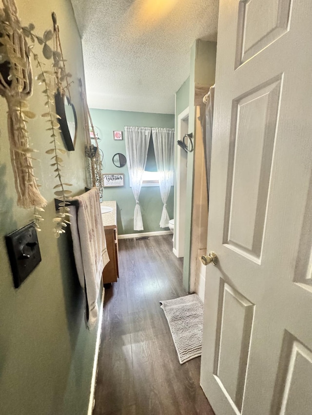 68 Red Witt Rd, Williamsburg, KY 40769 - interior space with a textured ceiling, baseboards, and dark wood-type flooring