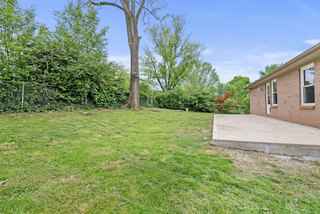 view of yard featuring fence and a patio area