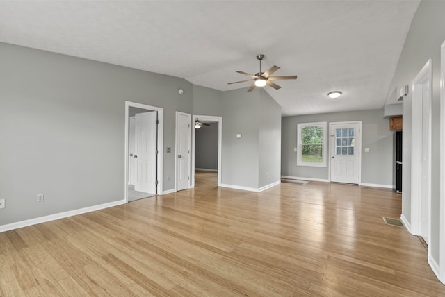 unfurnished living room featuring ceiling fan, visible vents, baseboards, lofted ceiling, and light wood-style floors