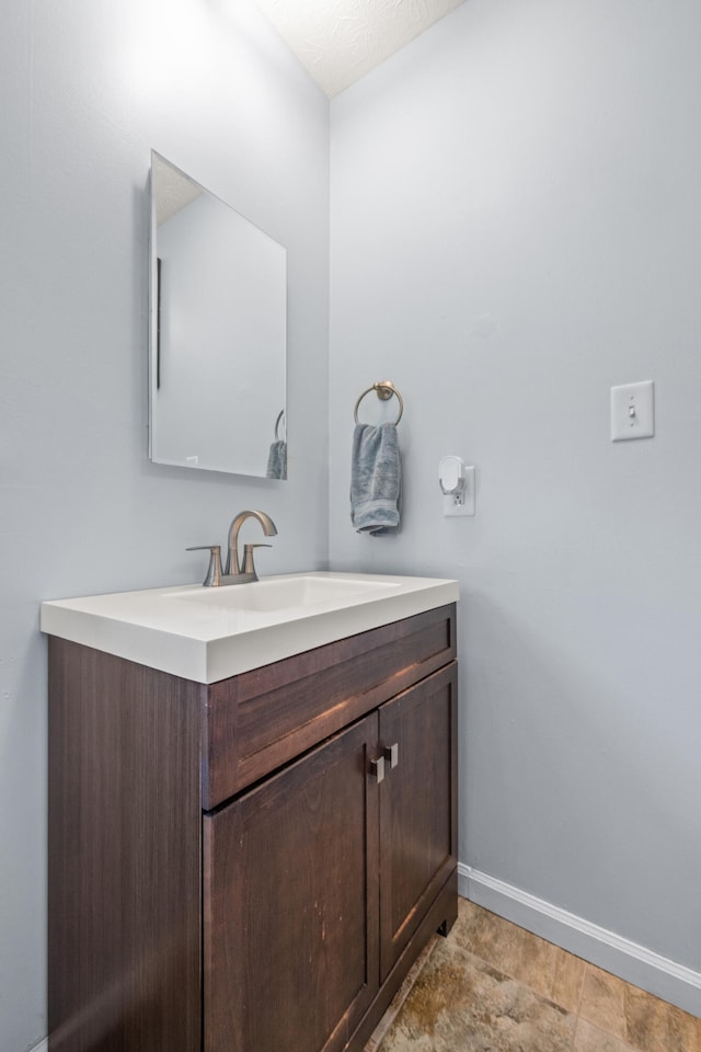 bathroom with baseboards and vanity