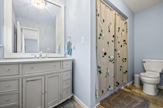 full bath with baseboards, stone finish floor, vanity, and toilet