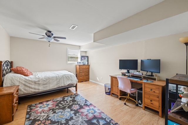 bedroom with a ceiling fan, baseboards, visible vents, and light wood-style flooring