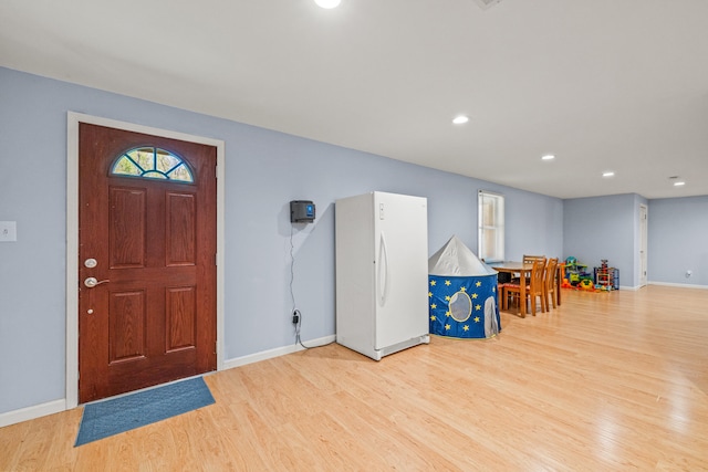 foyer featuring baseboards, recessed lighting, and wood finished floors