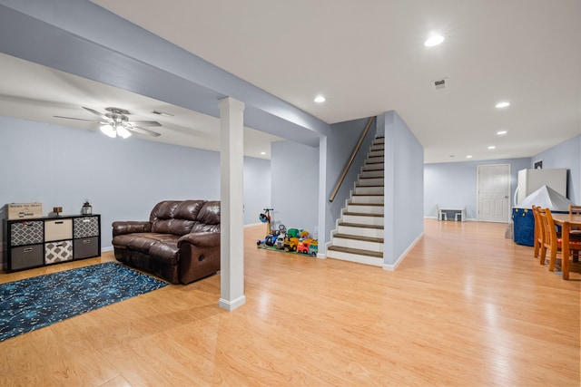 living area with recessed lighting, visible vents, stairway, and light wood-style floors