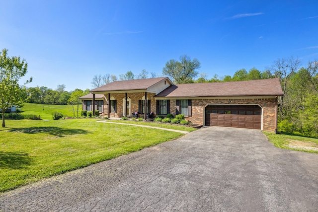 view of front of home with a front lawn, aphalt driveway, roof with shingles, brick siding, and an attached garage