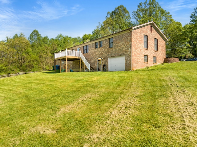 rear view of house with a lawn, a wooden deck, stairway, brick siding, and an attached garage