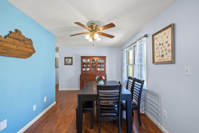 dining area with baseboards, a ceiling fan, and wood finished floors