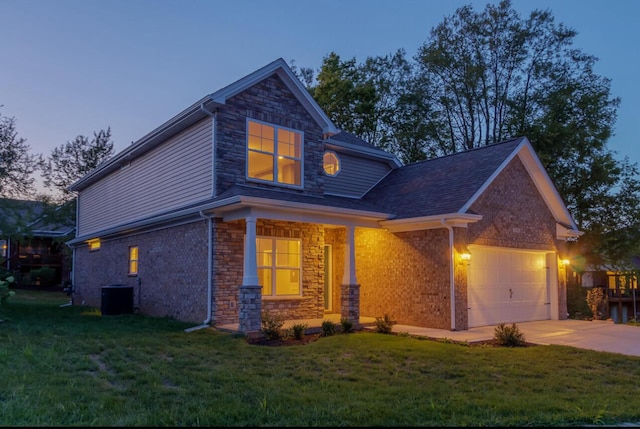 traditional home with an attached garage, a lawn, and driveway