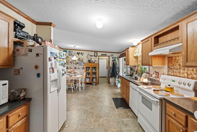 1142 Indian Creek Rd, Sadieville, KY 40370 - kitchen with crown molding, dark countertops, brown cabinets, under cabinet range hood, and white appliances