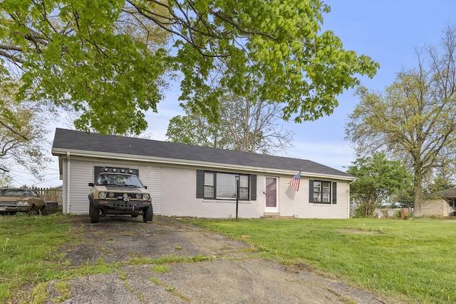 ranch-style house with a front yard and driveway