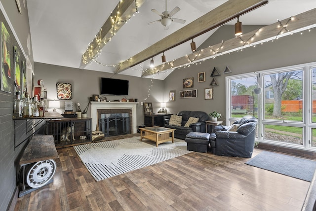 living room with beamed ceiling, wood finished floors, a fireplace, high vaulted ceiling, and a ceiling fan