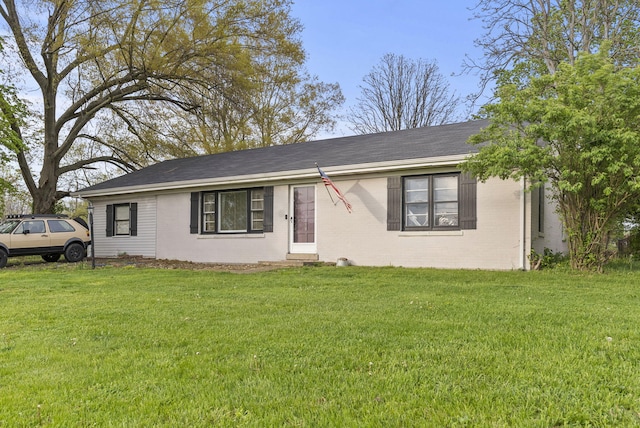 ranch-style house with brick siding, a front yard, and roof with shingles