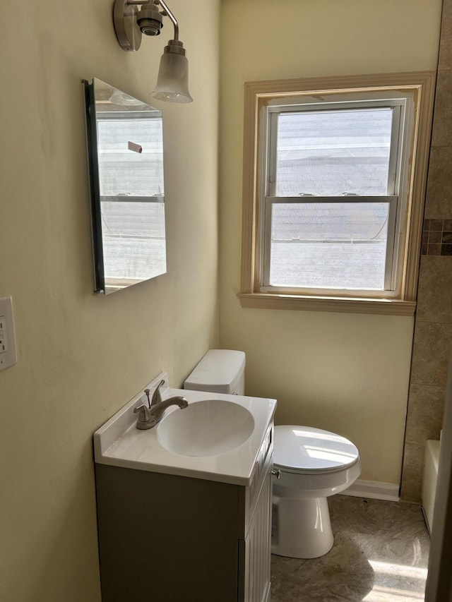 bathroom featuring toilet and vanity