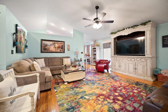 living area featuring light wood-style floors, a ceiling fan, and lofted ceiling
