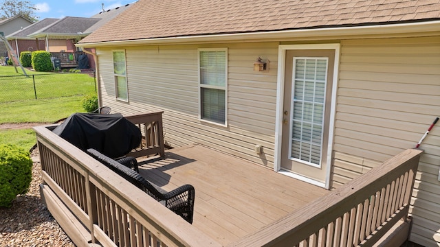 deck with fence and a lawn