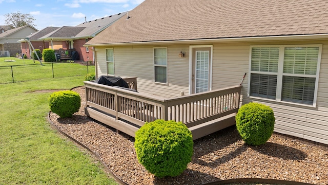 wooden terrace with fence and a lawn