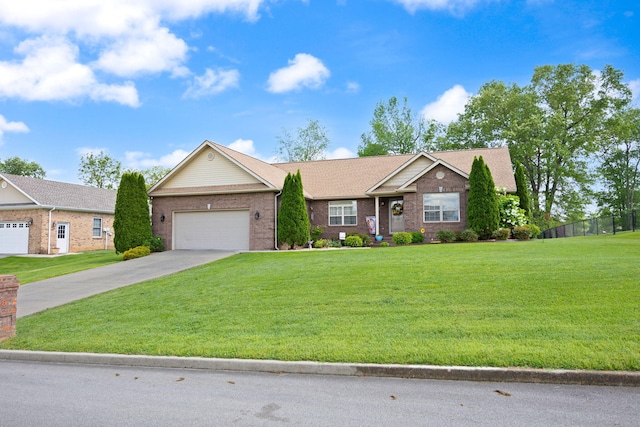 ranch-style home featuring a garage, fence, a front yard, brick siding, and driveway