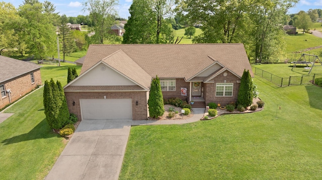 craftsman-style home featuring fence, an attached garage, brick siding, a front yard, and concrete driveway