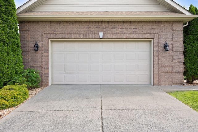 garage featuring concrete driveway