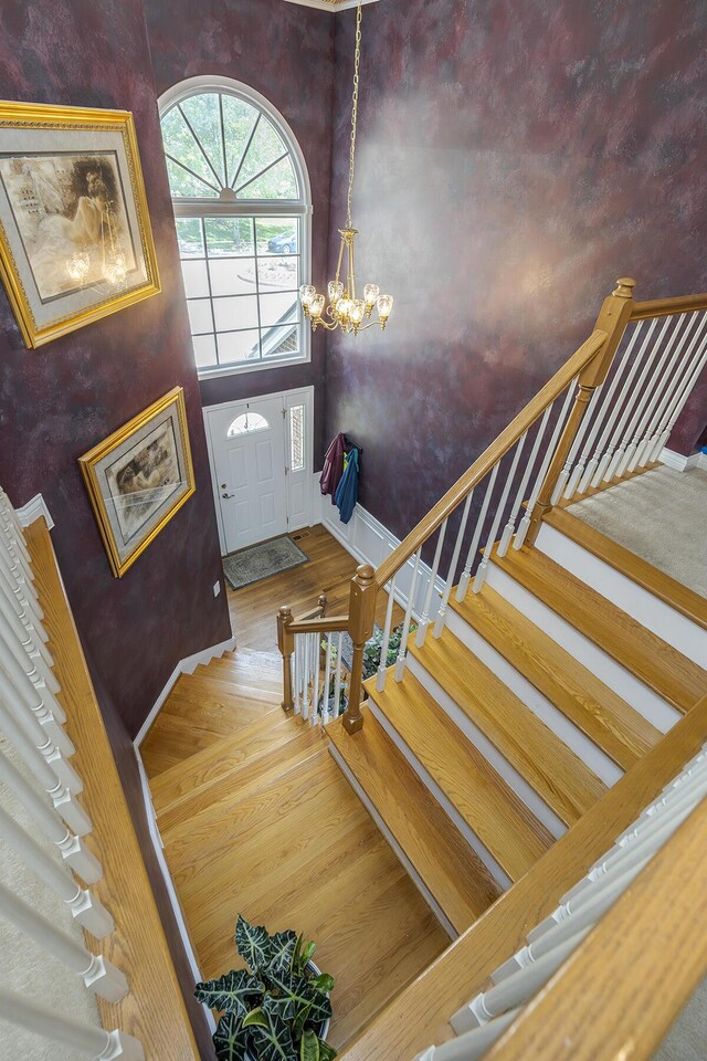 3120 Helmsdale Pl, Lexington, KY 40509 - stairway with a chandelier, baseboards, and wood finished floors