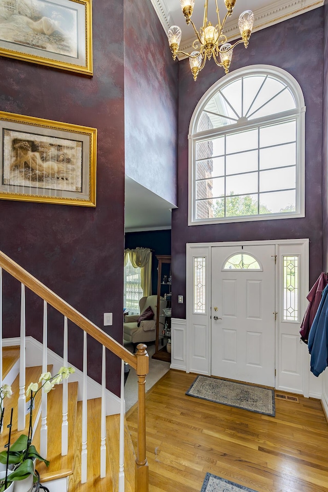 3120 Helmsdale Pl, Lexington, KY 40509 - entrance foyer featuring wood finished floors, a chandelier, healthy amount of natural light, stairway, and a towering ceiling