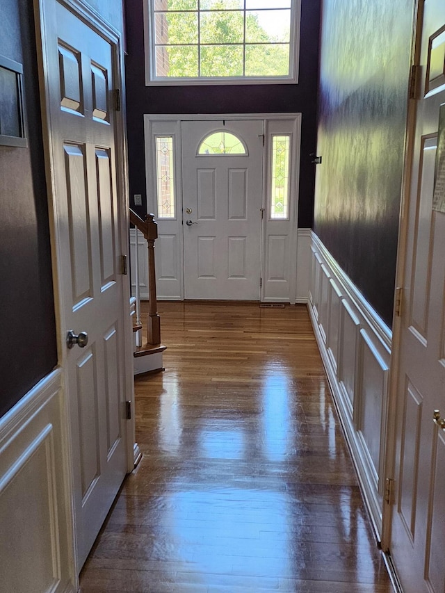 3120 Helmsdale Pl, Lexington, KY 40509 - foyer entrance featuring plenty of natural light, dark wood finished floors, wainscoting, and a decorative wall