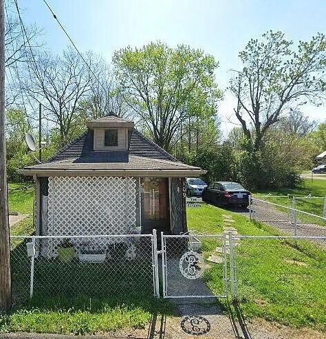 view of outdoor structure featuring a fenced front yard and a gate