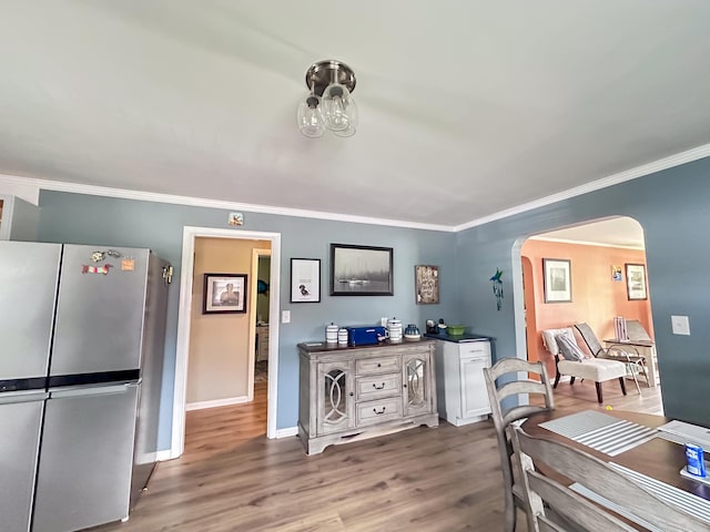 200 Summitt Ave, Somerset, KY 42501 - dining space featuring arched walkways, baseboards, ornamental molding, and wood finished floors