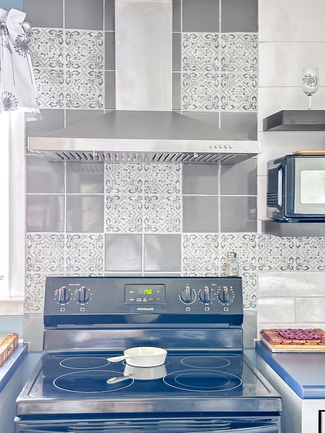 200 Summitt Ave, Somerset, KY 42501 - interior details with black microwave, tasteful backsplash, wall chimney exhaust hood, and electric stove