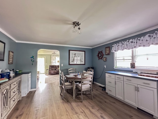 200 Summitt Ave, Somerset, KY 42501 - dining area with crown molding, arched walkways, plenty of natural light, and wood finished floors