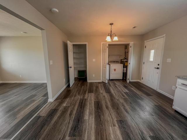 601 Heaton Ford Rd, Science Hill, KY 42553 - unfurnished dining area with a chandelier, baseboards, washer / dryer, and dark wood-type flooring