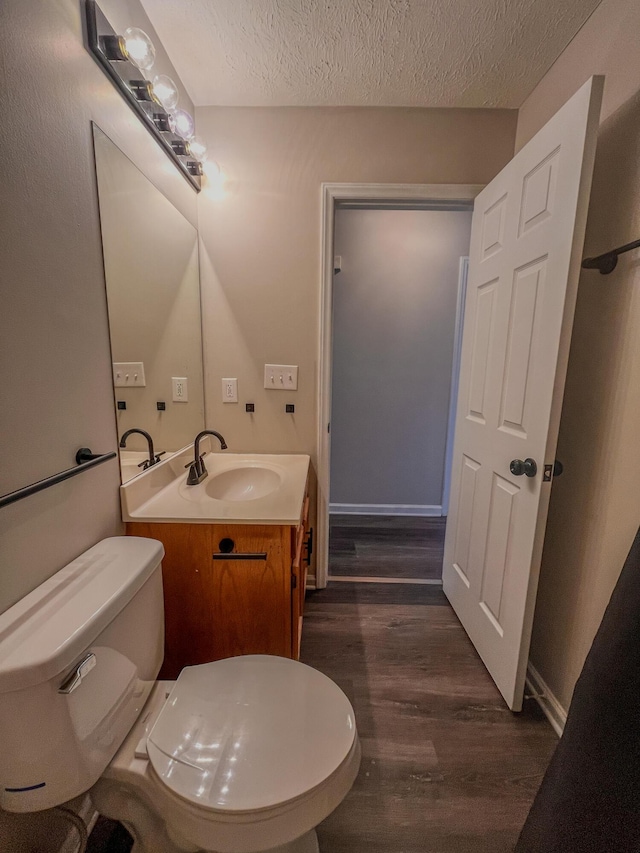 601 Heaton Ford Rd, Science Hill, KY 42553 - bathroom featuring vanity, a textured ceiling, wood finished floors, and toilet