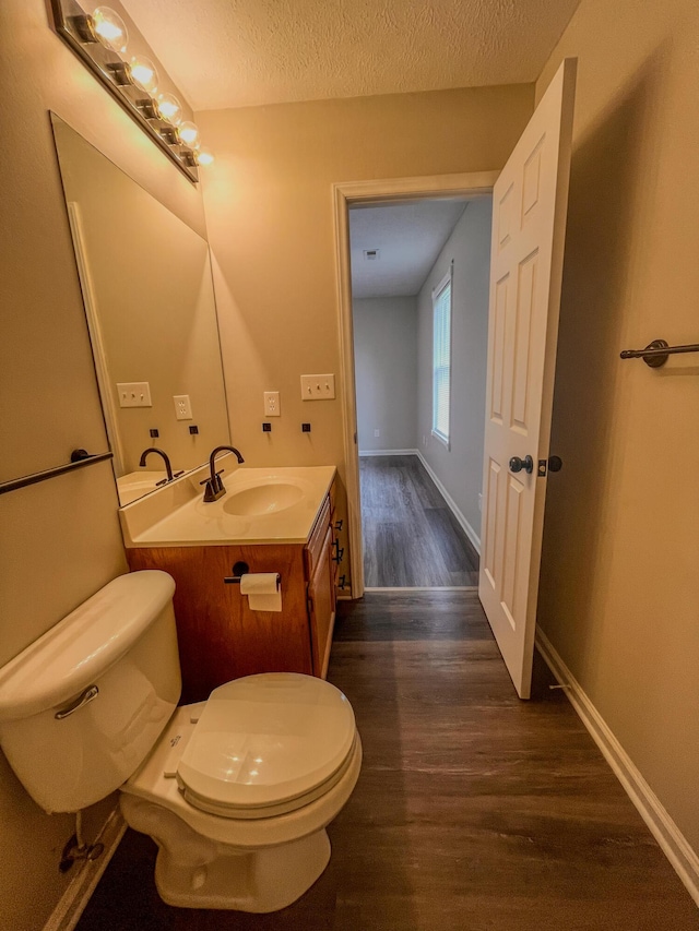 601 Heaton Ford Rd, Science Hill, KY 42553 - half bathroom with a textured ceiling, wood finished floors, vanity, baseboards, and toilet