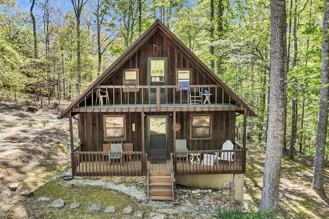 chalet / cabin featuring board and batten siding and a porch