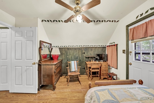 bedroom featuring ceiling fan, light wood-style flooring, and lofted ceiling