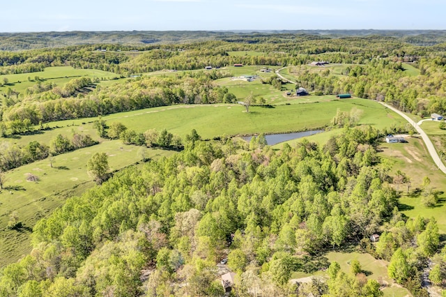 aerial view featuring a water view and a forest view