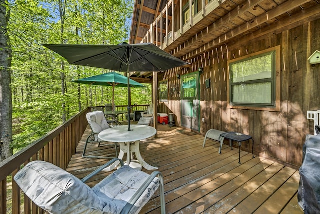 deck with outdoor dining area