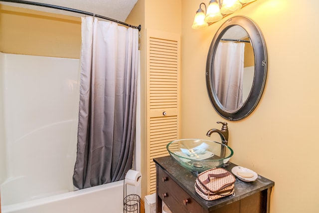 bathroom featuring shower / bathtub combination with curtain and vanity