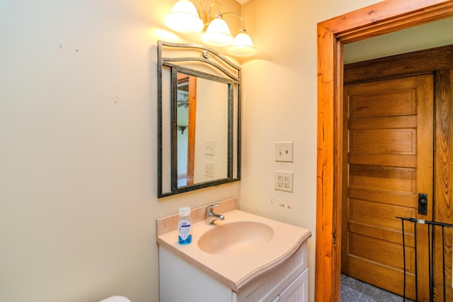 bathroom with vanity and a chandelier