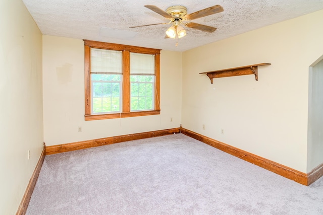 unfurnished room with carpet, ceiling fan, a textured ceiling, and baseboards