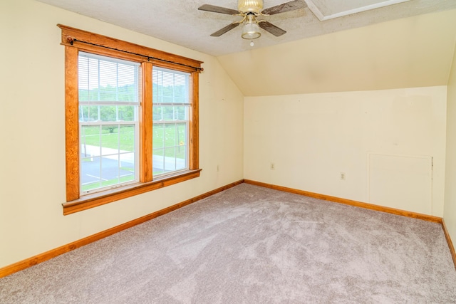 bonus room with carpet, lofted ceiling, baseboards, and ceiling fan