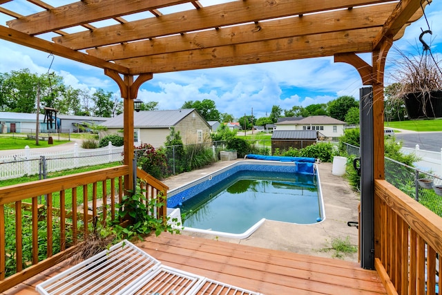 view of swimming pool featuring a fenced backyard, a pergola, a residential view, and a wooden deck
