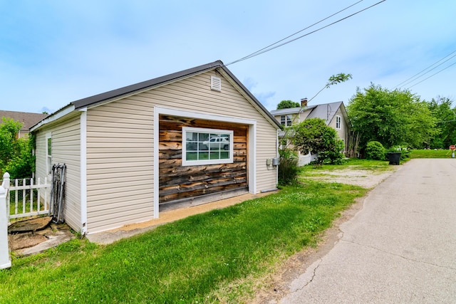 view of home's exterior featuring an outbuilding