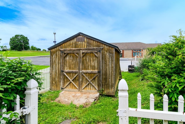 view of shed featuring fence