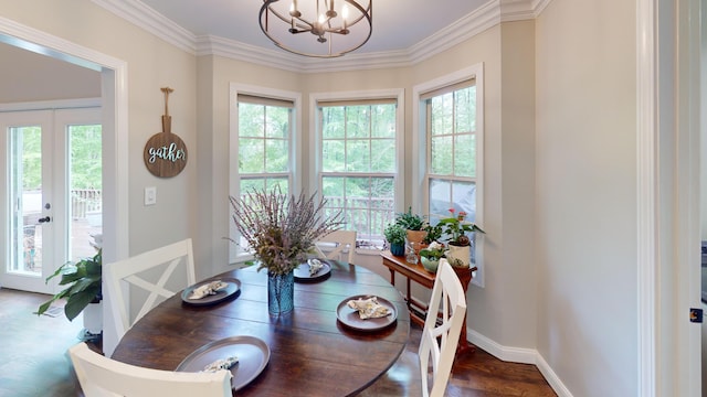 dining area featuring ornamental molding, a notable chandelier, french doors, and baseboards