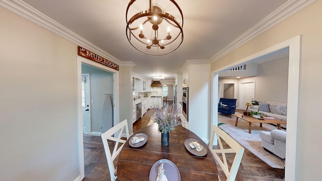 dining space with ornamental molding, an inviting chandelier, baseboards, and dark wood finished floors