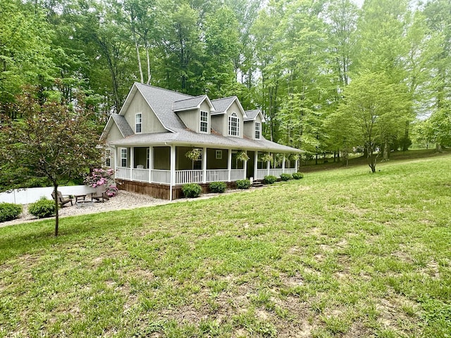 farmhouse inspired home with a front yard, a shingled roof, and covered porch