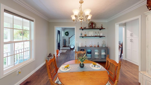 dining room with dark wood finished floors, a notable chandelier, and a wealth of natural light